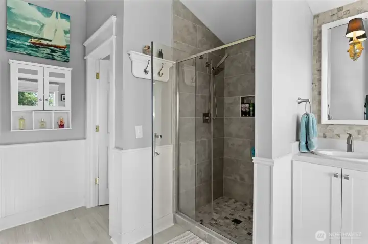 Remodeled primary bath with large, custom-tiled shower