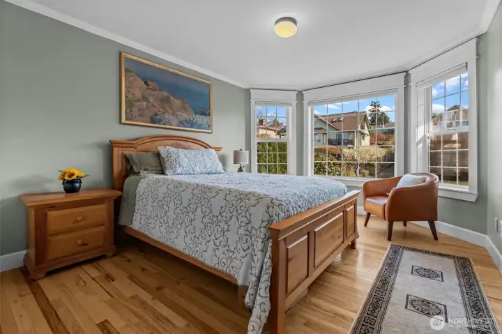 Bedroom 2 with bay windows and hardwood floors