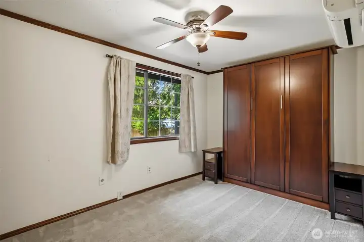 Guest bedroom with a foldout Murphy bed.