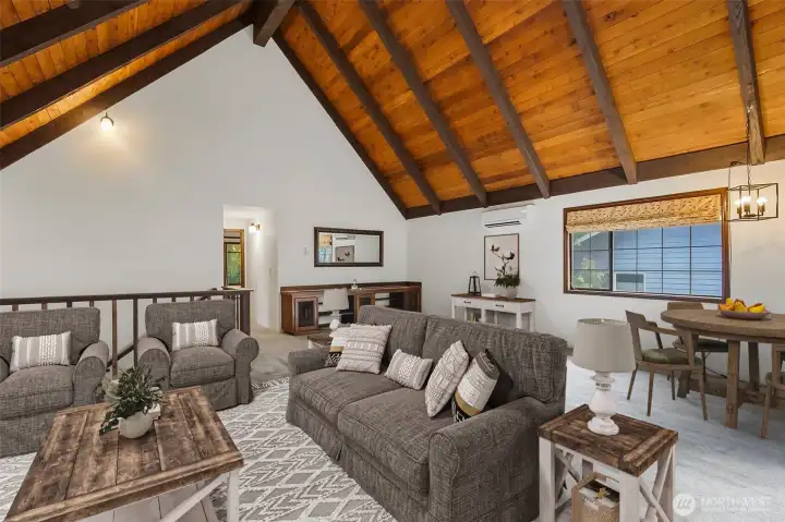 Upper-level family room with a Wet Bar & stone fireplace.