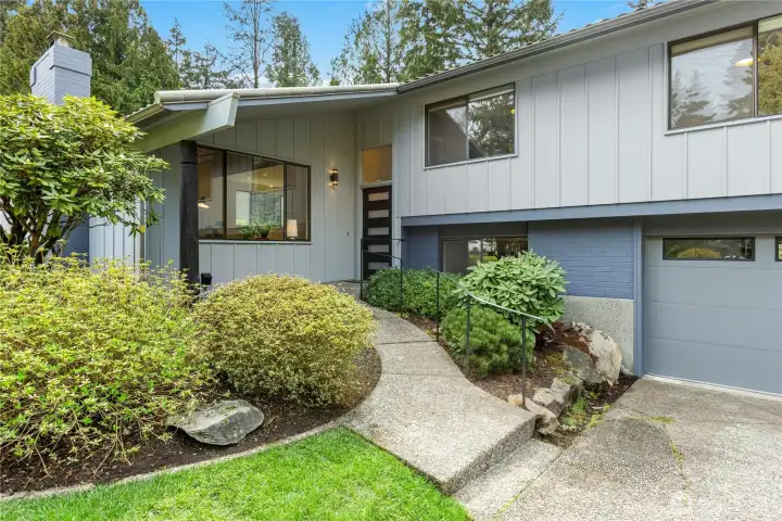 A covered front porch welcomes you home and greets your guests. Exterior updates include a metal tile roof, new insulated garage doors and a new front door. The heat pump was also replaced in 2024.