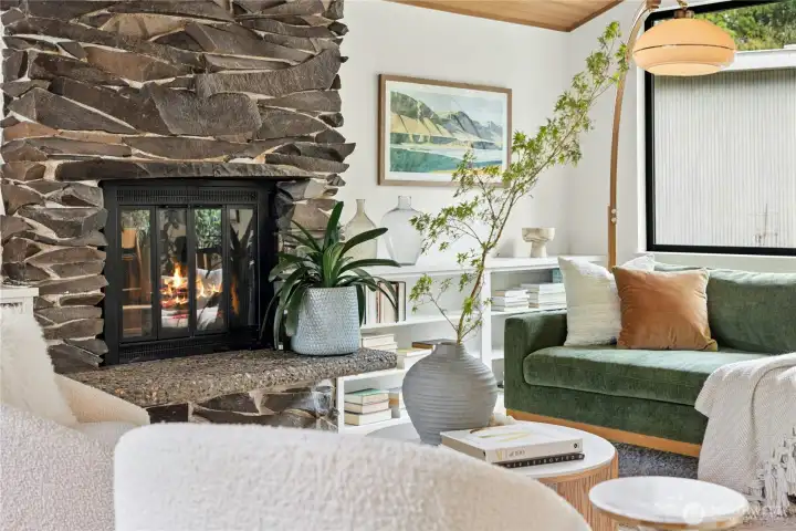 The original basalt fireplace is the centerpiece of this room. It is flanked by built-in bookshelves for nice storage.