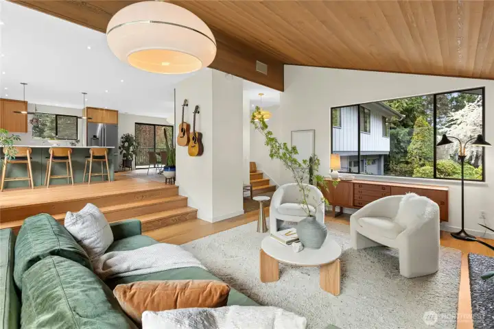 The living room looking up to the new kitchen and dining areas.