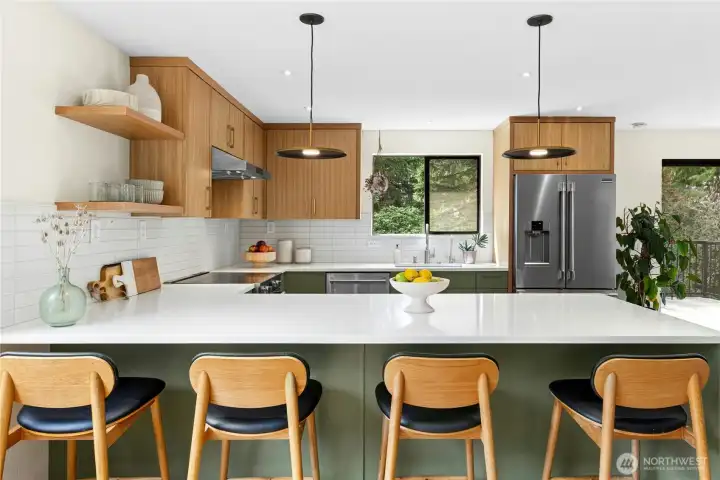 The all-new modern kitchen with designer cabinetry, quartz countertops, and stainless steel appliances including an induction range.