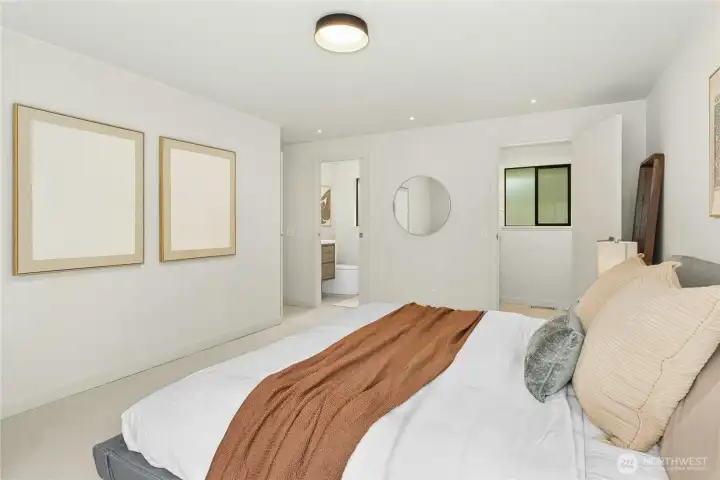 The primary suite is at the end of the hall and has an adjoining bathroom and walk-in closet.