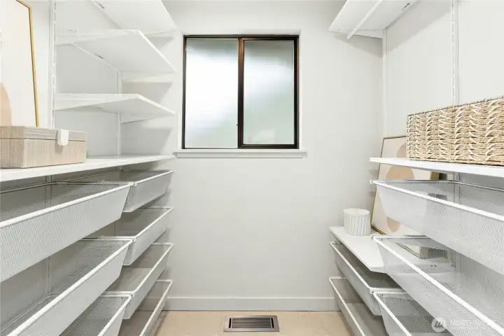The built-in closet system in the primary closet.