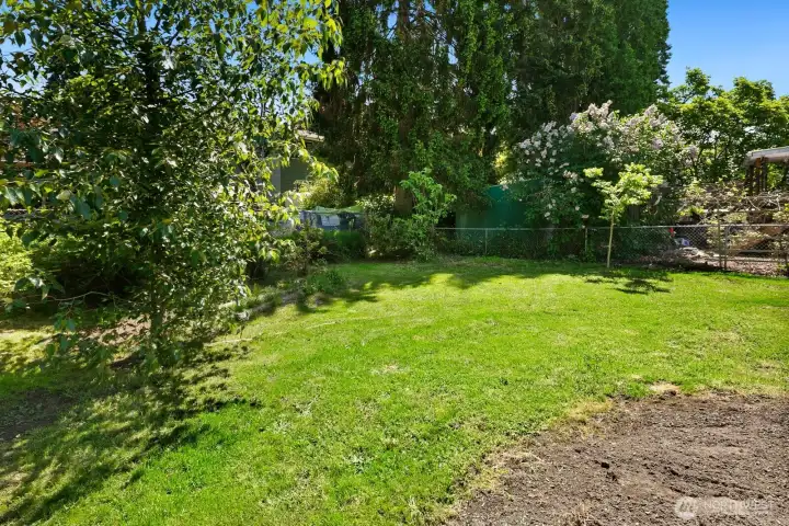 Gardening is a pleasure in this yard featuring a fig tree, chestnut tree, and prolific blueberry bushes