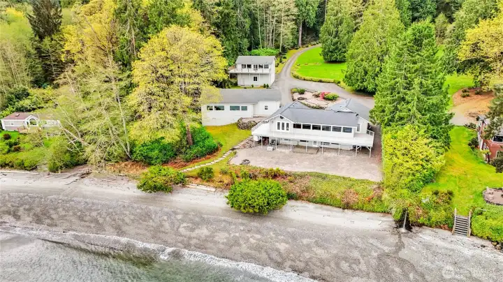 There is so much to love here. The custom home, the professional wood-shop, the two huge garages, the ADU, and two tax parcels, making this as private as no-bank waterfront can be.