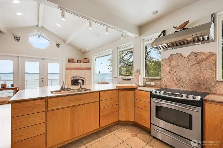 Looking out over the water from the kitchen you can see the propane fireplace for warmth and ambiance.
