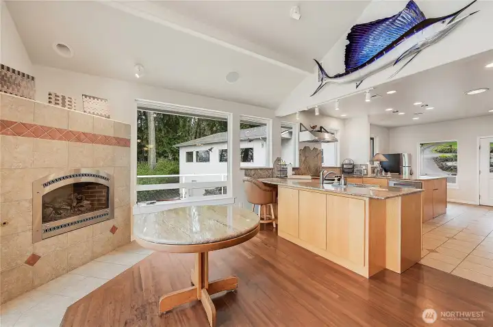 Hardwood floors meet tile in the dining room. Recessed lighting all around.