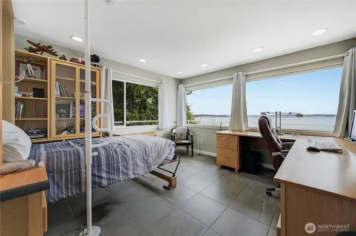 The office features grey slate floors and another incredible view.