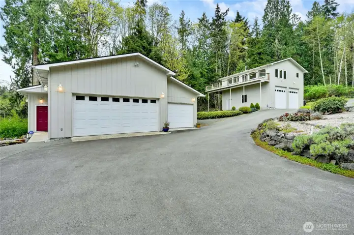 Looking up from the house you will find both of the incredible garages. Three bays in the first with a full professional wood shop attached, and the other has high bays for your boats and RVs with an ADU up above.