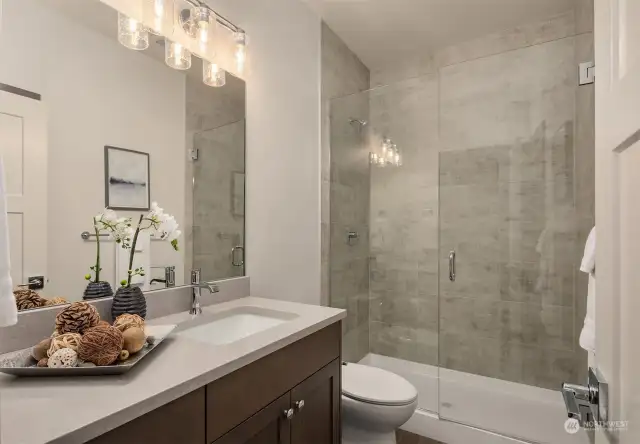 Elegant bath with large tile shower & Euro glass door.