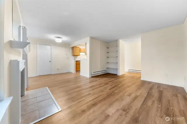 open concept, living room and dining room, with built in shelving