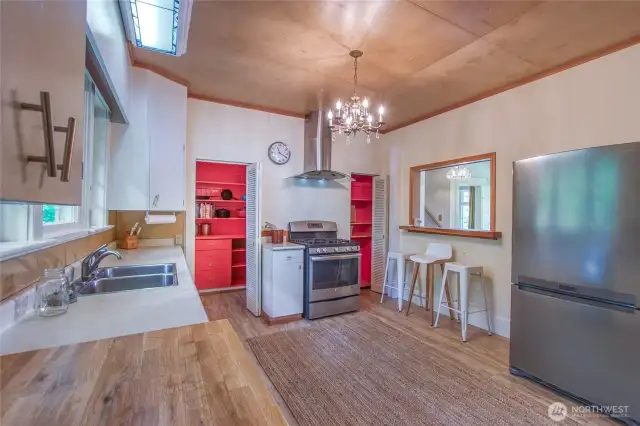 A pass-through window opens the kitchen up to the front hallway.