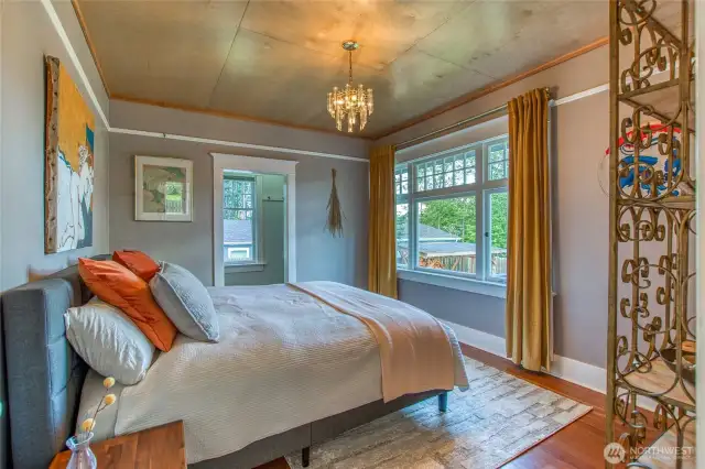 Two bedrooms are located on the main level. the front bedroom looks out a large east-facing window.