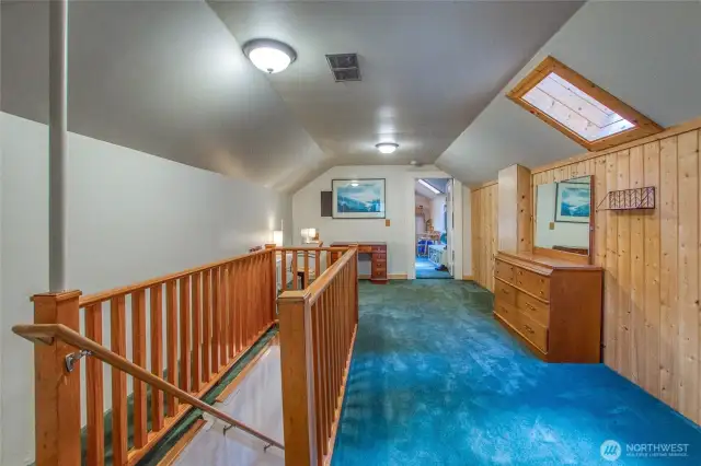 The upstairs level would be a great primary suite, with a bonus area, bedroom, and 3/4 bathroom.