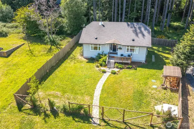 A fully fenced section of the property around the home.