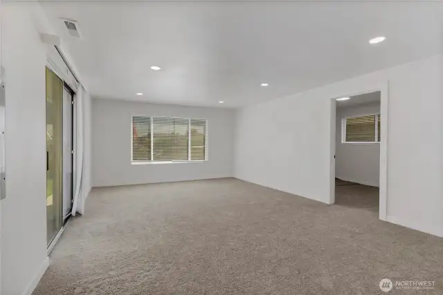 The roomy family room is carpeted for cozy gatherings