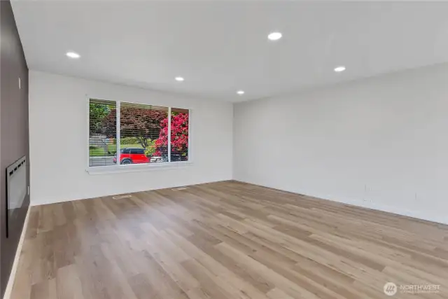 Generous living room with new electric fireplace feature wall
