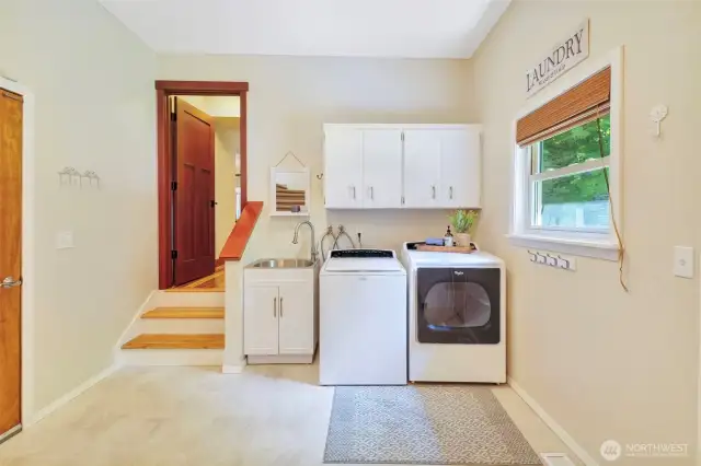 Laundry room with door to garage and another door to backyard.