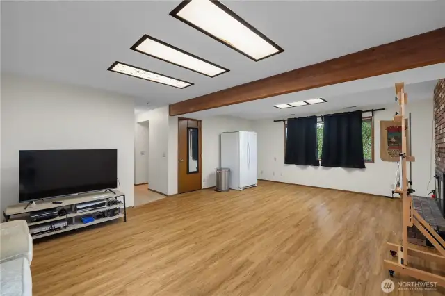 The lower-level family room with newer laminate flooring.