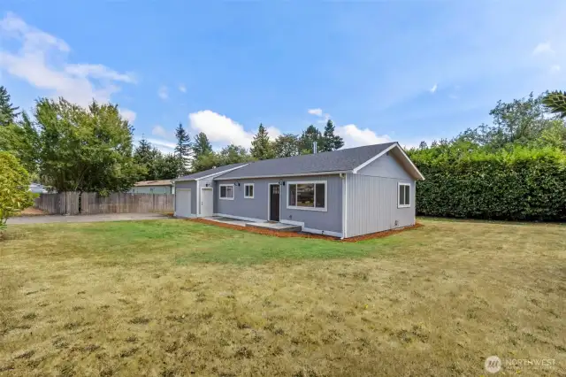 Great yard with mature rhodies, plum trees and pear trees along with a massive backyard laurel hedge for privacy