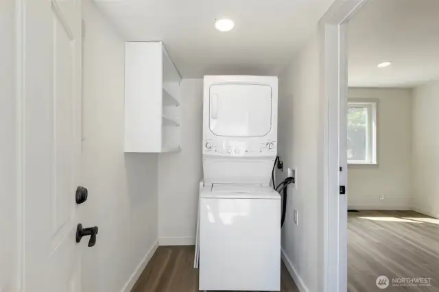 The laundry/ mudroom with shelving and apple storage floor space for another shelf.