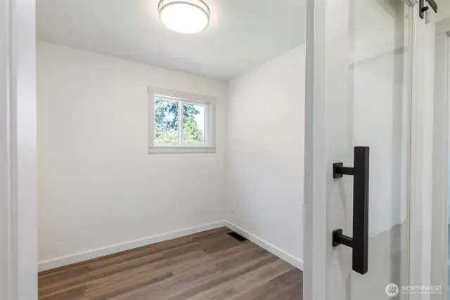 Office/ den/ mini bedroom with sliding glass barn style door.
