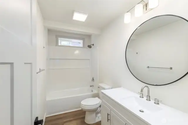 Hallway/ guest bathroom with all new fixtures, cabinets and appliances.