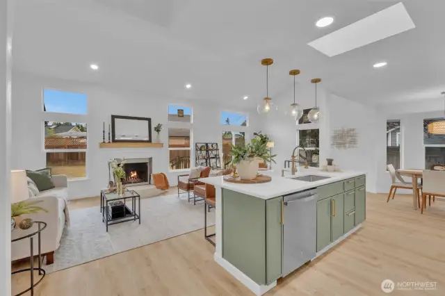 Vaulted ceilings with skylights and expansive windows flood this main living area with natural light throughout the day.