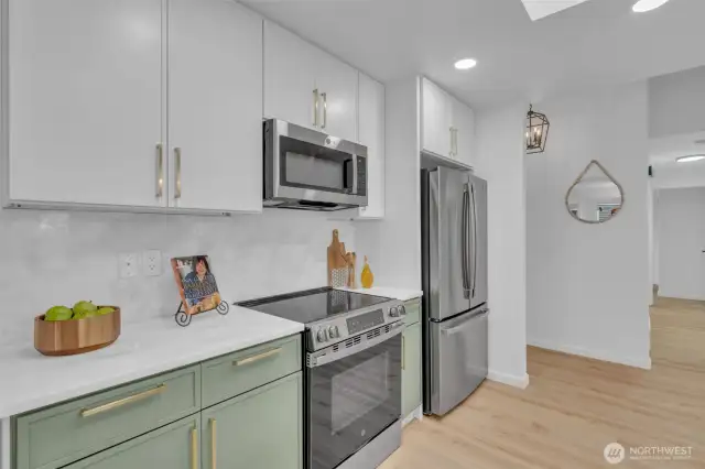 The kitchen flows directly to the front entry and bedroom hallway, offering a practical and well-planned layout.