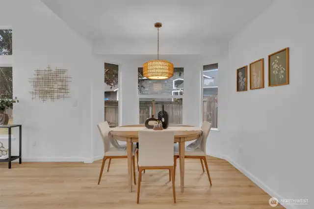 The dining nook is surrounded by windows on three sides, filling the space with natural light throughout the day.