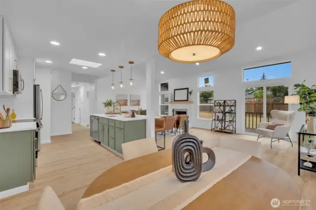 From the dining area, you can see straight through to the kitchen island and living room with its cozy fireplace and large patio doors.
