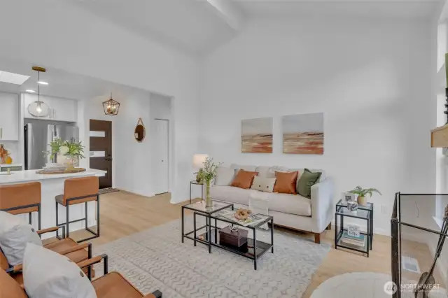From the living area, the home's open flow is evident with clear sightlines to the kitchen island and front entry.
