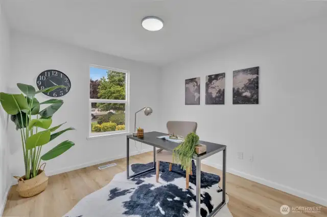 The third bedroom is currently set up as a home office, showcasing the flexible living potential of this well-lit space.