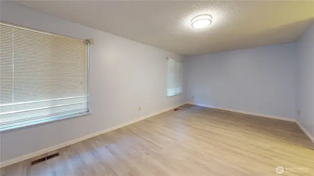 Main floor primary suite features a walk-in closet, private bathroom and more.