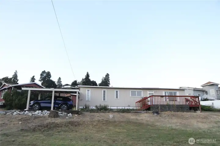 This property features a convenient carport with access to electrical outlets and offers ample parking for up to four vehicles—perfect for households with multiple drivers or frequent guests. Room for your toys like RV or boat!