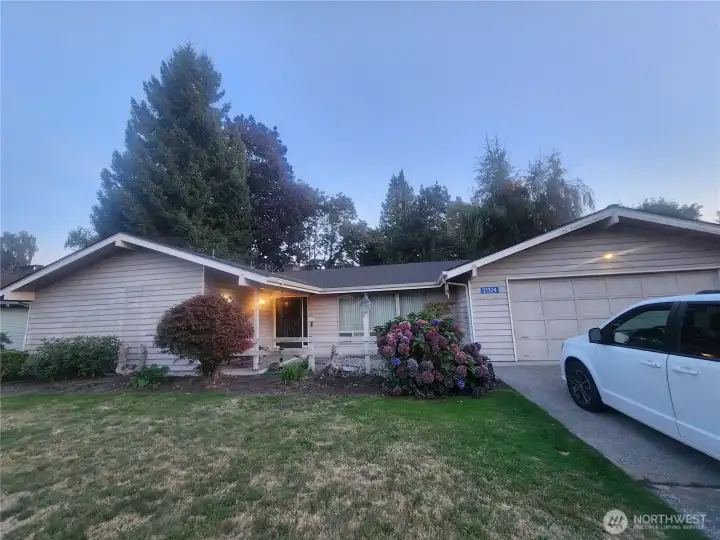 Front of rambler with covered patio and 2-car garage in coveted Rolling Ridge neighborhood