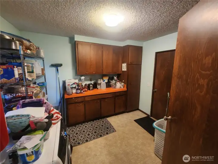Laundry room, utility room and pantry with a door to go outside and a door to garage
