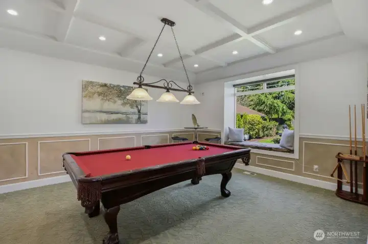 The formal living room currently transformed into an inviting game room featuring a beautiful pool table.