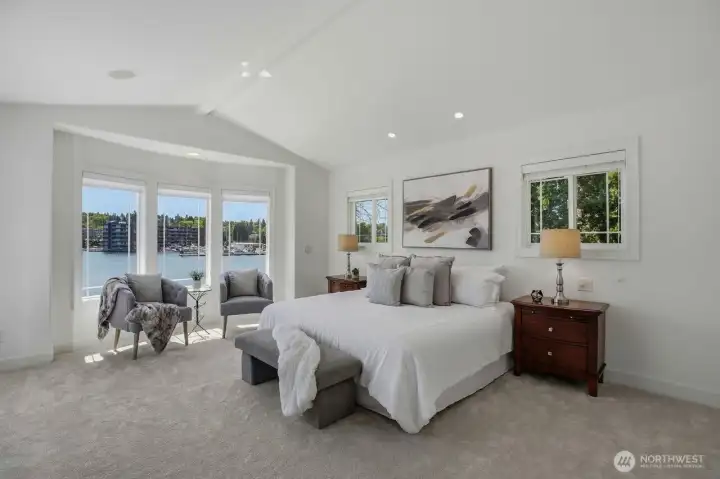 Spacious primary suite with a wall of windows to take in the stunning views.