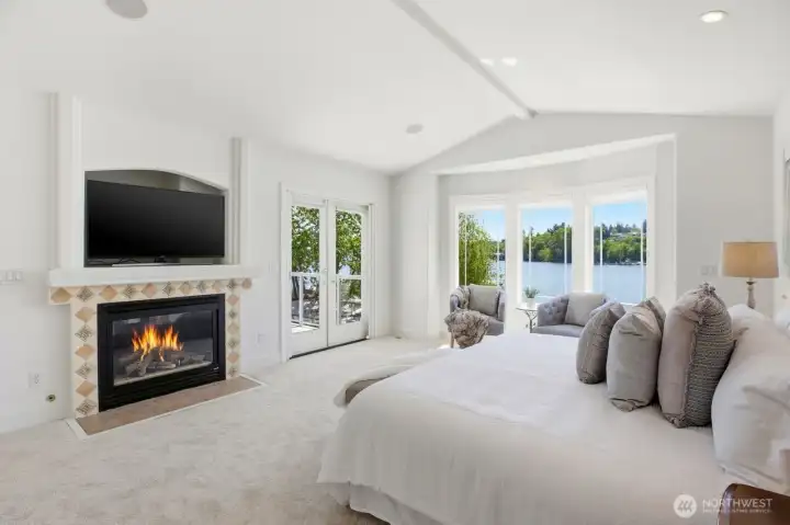 Primary suite with fireplace and french doors leading to a private deck.