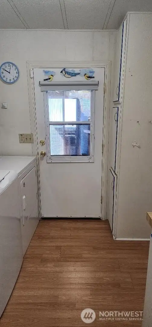 Laundry with exit door. Perfect mudroom with sink