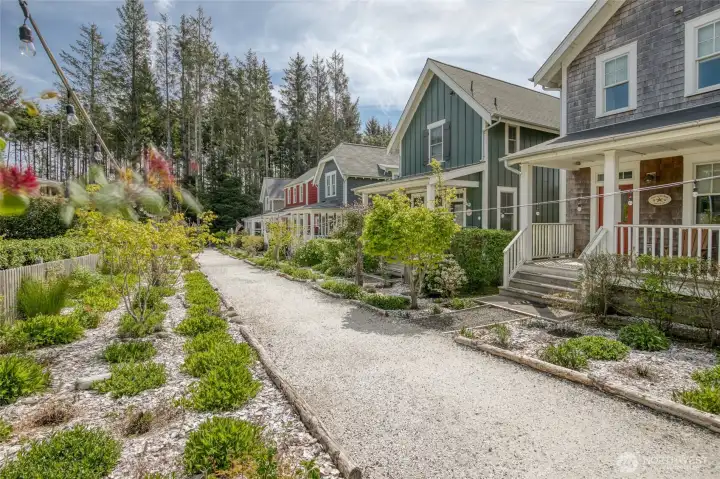 Nestled into a lush landscape, the Orchard Walk is a coveted pocket of Seabrook with a quiet setting and path that leads to a serene fountain with a place to gather. The path is lit with string lights at night to create a peaceful space for you to enjoy. The covered front porch is the perfect place to take it all in!