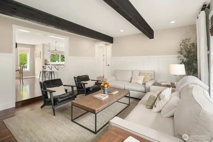 The living room flows effortlessly toward the sun-filled office and beyond, highlighting the home's thoughtful open layout and the French doors that invite the outdoors in year-round.