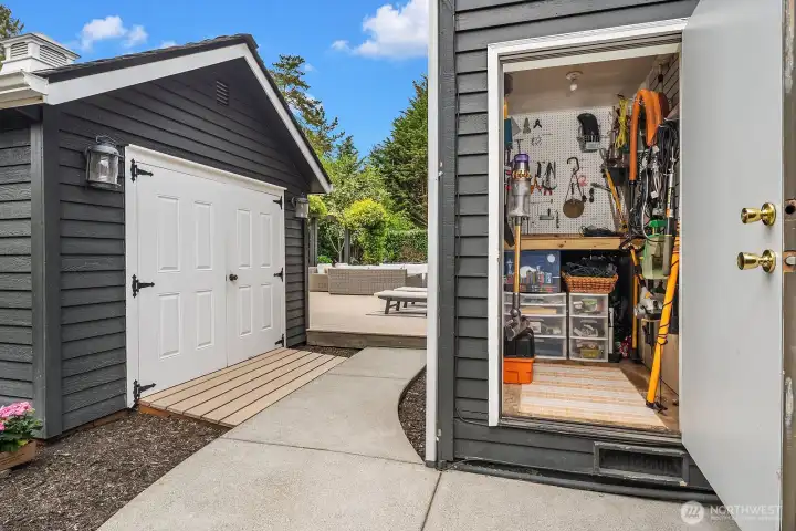 The versatile outbuilding offers a peek inside at its impressive utility — whether used as a workshop, storage space, or creative flex space, it's a valuable bonus that sets this property apart.