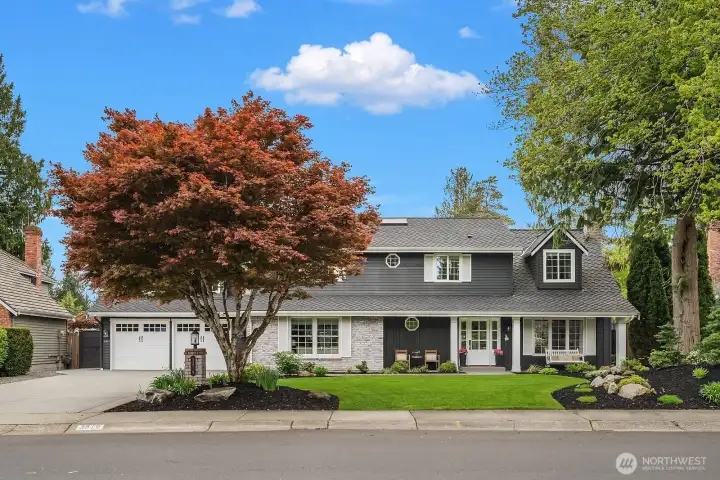 Stunning curb appeal with a classic Buchan Homes facade, vibrant mature landscaping, and a beautifully manicured lawn under a canopy of lush trees, a warm and welcoming first impression in the highly sought after Timberline neighborhood.