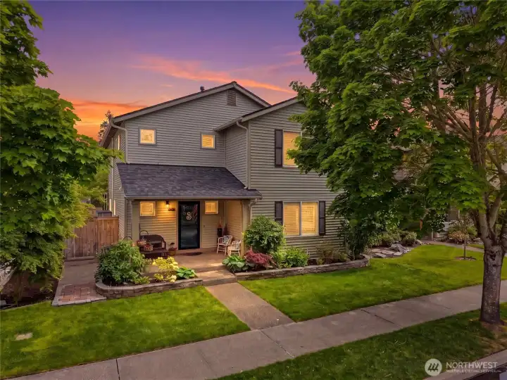 A covered front porch and beautifully maintained landscaping create a welcoming first impression with plenty of space to sit, relax, and enjoy the neighborhood atmosphere. Ask about the Trimlights! A covered front porch and beautifully maintained landscaping create a welcoming first impression with plenty of space to sit, relax, and enjoy the neighborhood atmosphere. Ask about the Trimlights!