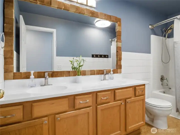 The full guest bathroom offers dual sinks and a functional layout designed to accommodate busy households with ease. The full guest bathroom offers dual sinks and a functional layout designed to accommodate busy households with ease.